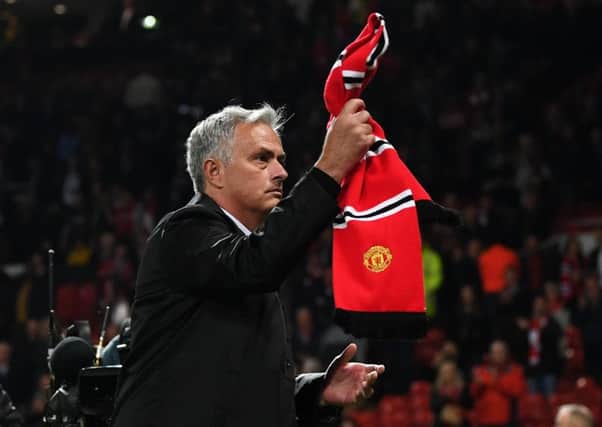 Jose Mourinho waves a Manchester United scarf towards fans after his side's 3-0 defeat by Tottenham Hotspur at Old Trafford. Picture: Michael Regan/Getty