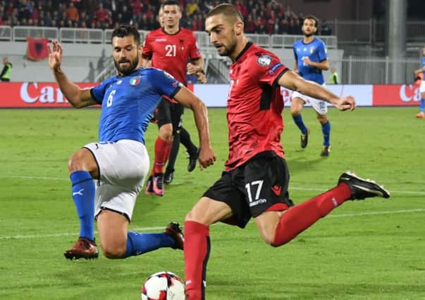 Eros Grezda, right, playing against Italy in World Cup qualification. Picture: AFP/Getty