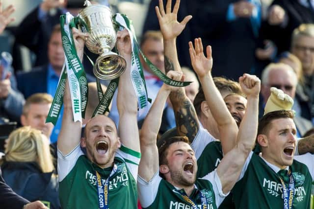 David Gray (left) lifts the Scottish Cup, as he and his team mates celebrate vistory at Hampden in 2016. Picture: SNS.
