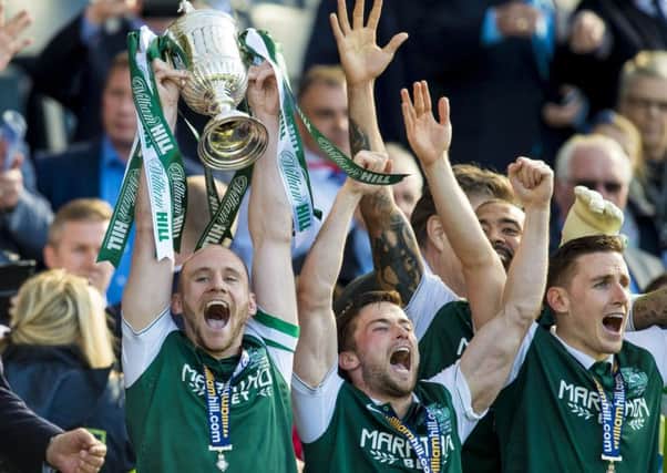 David Gray (left) lifts the Scottish Cup, as he and his team mates celebrate vistory at Hampden in 2016. Picture: SNS.
