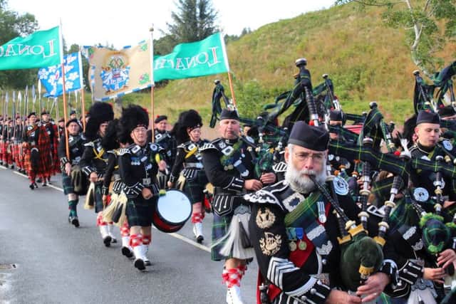 Lonach Pipe Band lead the men on their traditional march. PIC: Contributed.