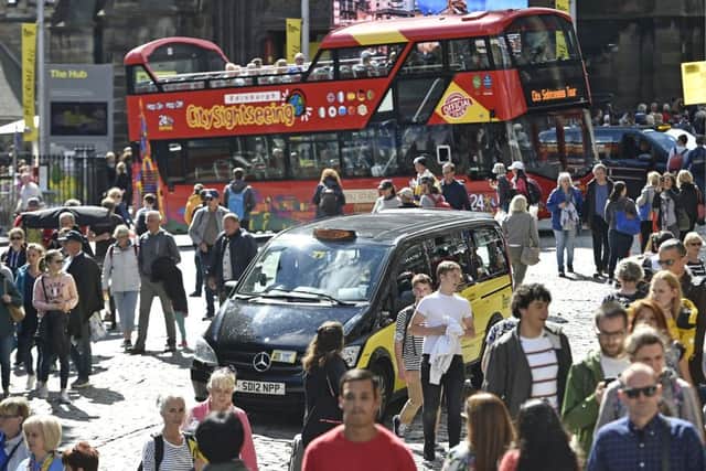 City council chiefs are facing demands to ban traffic from key thoroughfares during the main Edinburgh Festival season amid claims they are now intolerable for people to walk down in August. Picture: Neil Hanna Photography.