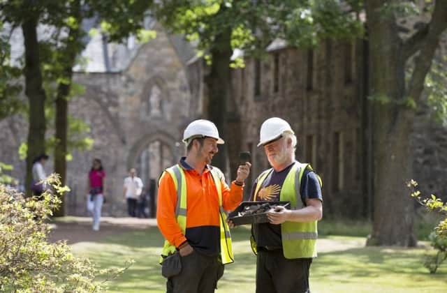 Archaeologists Alan Radley (right) and Jamie Lewis going about their work at the Abbey Strand gate, Holyrood Palace, Edinburgh. Photograph: David Cheskin.