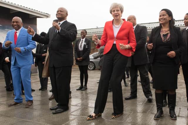 Prime Minister Theresa May dancing with students and staff in Cape Town. Picture: Stefan Rousseau/PA Wire