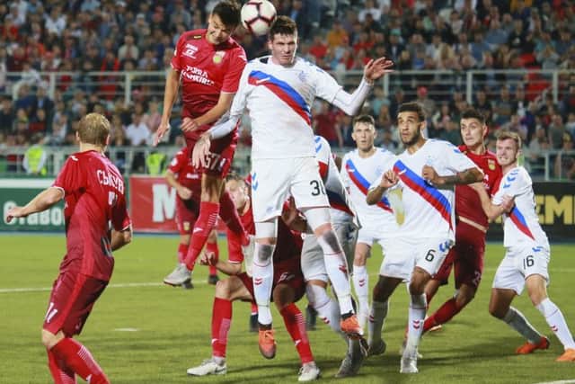 Ufa's Vyacheslav Krotov and Rangers striker Kyle Lafferty battle for the ball at the Neftyanik stadium. Picture: AP