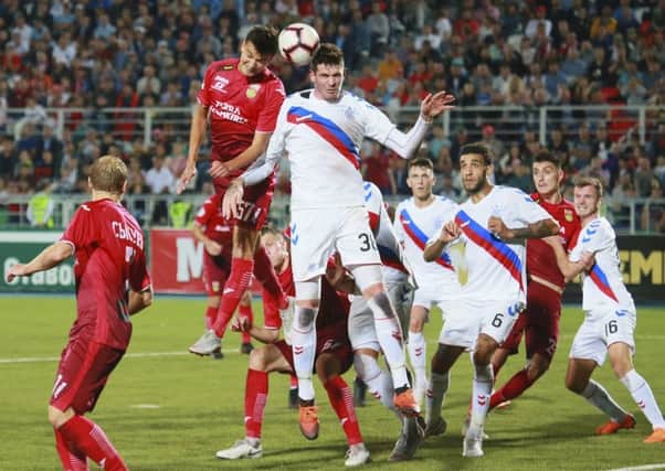 Ufa's Vyacheslav Krotov and Rangers striker Kyle Lafferty battle for the ball at the Neftyanik stadium. Picture: AP