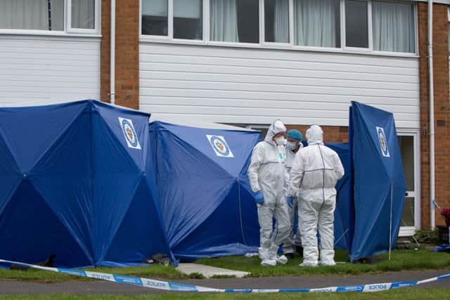 Forensics officers at the scene after a 49- year-old mother and her 22-year-old daughter were stabbed to death in Northdown Road, Solihull.  Picture: SWNS