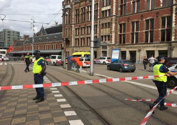 Security officials cordon off an area outside The Central Railway Station in Amsterdam after two people were hurt in a stabbing incident. Picture: AFP/Getty