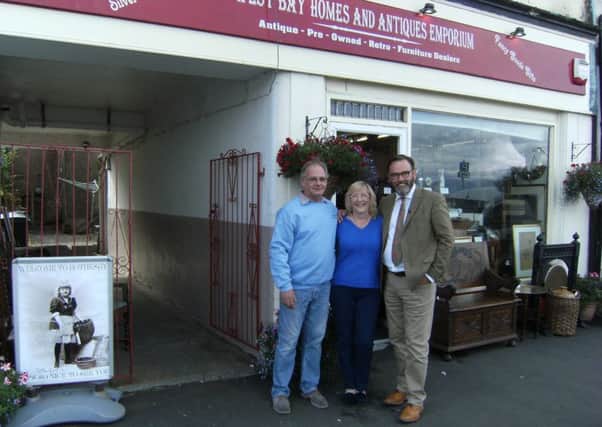 Paul Laidlaw from the Antiques Road Trip at  West Bay Homes and Antiques with owners Marilyn and Neville Albone.