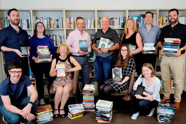 Staff and directors at Palimpsest now own the company, including managing director Craig Morrison (third from left in back row), director Ruth Morrison (seated left), director Andy O'Neill (fourth from left in back row), director John Forsyth (sixth from left in back row) and trustee director Sarah Eddie (far right in lower row). Picture: Contributed
