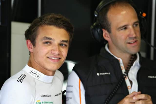 MONZA, ITALY - AUGUST 31: Lando Norris of Great Britain and McLaren F1 talks with race engineer Tom Stallard in the garage during practice for the Formula One Grand Prix of Italy at Autodromo di Monza on August 31, 2018 in Monza, Italy. (Photo by Charles Coates/Getty Images)