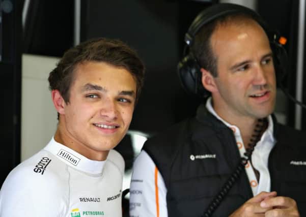 MONZA, ITALY - AUGUST 31: Lando Norris of Great Britain and McLaren F1 talks with race engineer Tom Stallard in the garage during practice for the Formula One Grand Prix of Italy at Autodromo di Monza on August 31, 2018 in Monza, Italy.  (Photo by Charles Coates/Getty Images)