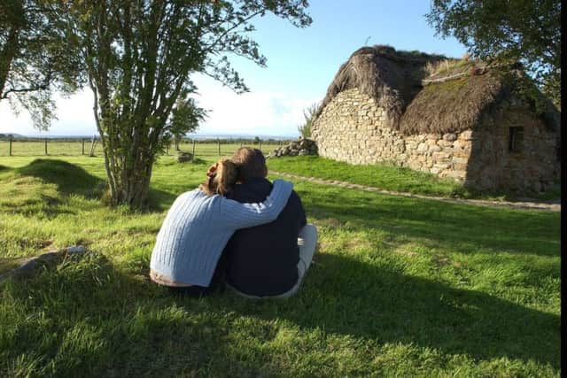 A couple sit by The old Leanach cottage which will open next year to the public following renovation and restoration.  PIC:   TSPL/Robert Perry.