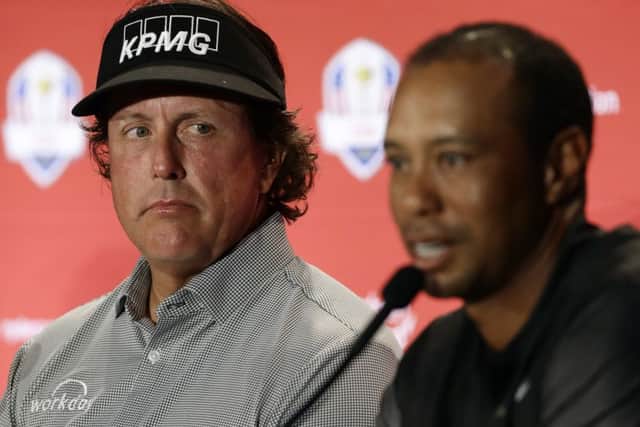 Phil Mickelson, left, listens to Tiger Woods after they were announced as captain's picks for the US Ryder Cup Team. Picture: Matt Slocum/AP