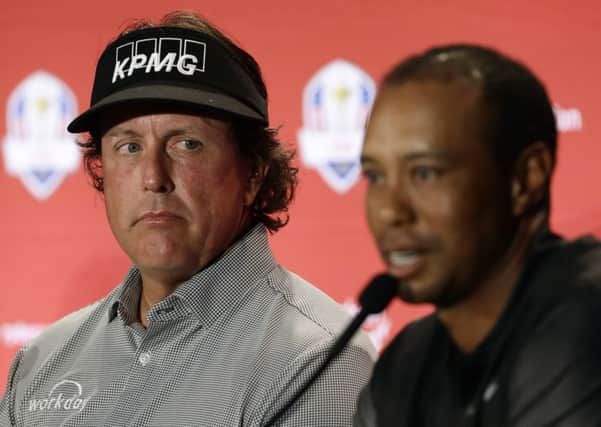 Phil Mickelson, left, listens to Tiger Woods after they were announced as captain's picks for the US Ryder Cup Team. Picture: Matt Slocum/AP