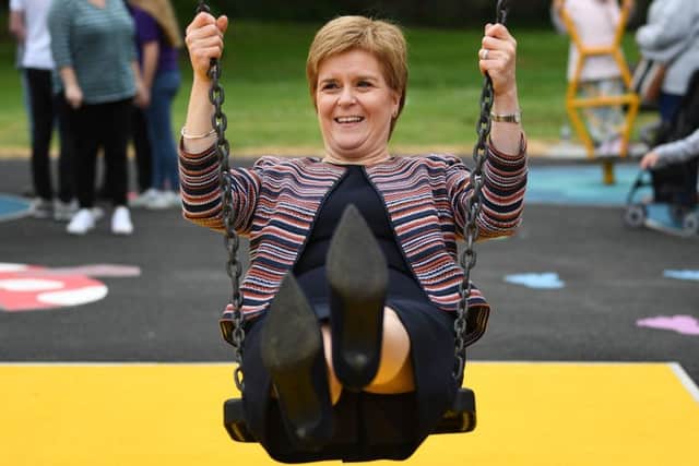 First Minister Nicola Sturgeon sits on a swing as she officially opens a play park in Dunfermline.  (Photo by Jeff J Mitchell/Getty Images)