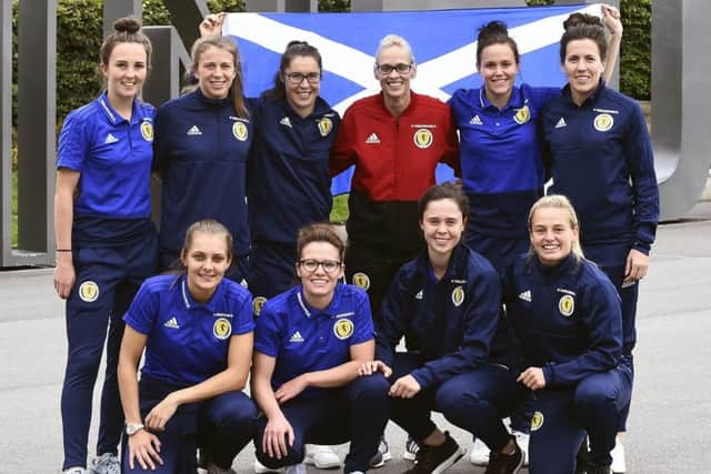 Members of Scotland's triumphant squad pose for a picture at Edinburgh Airport after arriving home from Albania. Picture: Lisa Ferguson