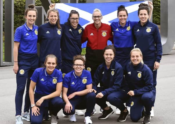 Members of Scotland's triumphant squad pose for a picture at Edinburgh Airport after arriving home from Albania. Picture: Lisa Ferguson