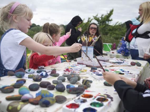 Painting pebbles at the Summer Festival