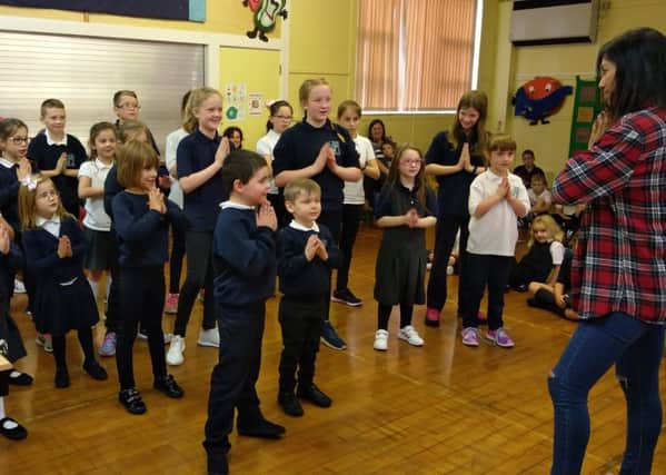 Shanta teaches pupils a Nepalese song and dance