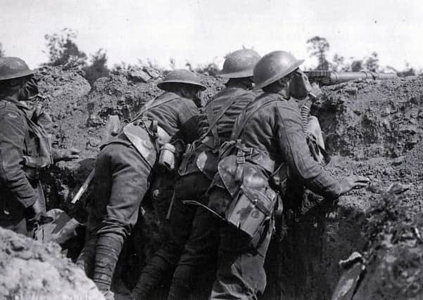 Royal Scots wearing gas masks manning a Lewis gun on the Western Front in 1918.