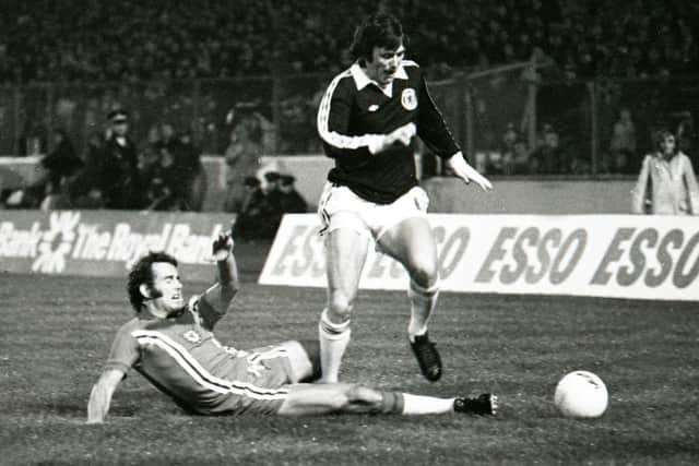 Scotland's Eddie Gray holds off Wales' Malcolm Page (left) Eddie Gray holds off Wales' Malcolm Page in a World Cup qualifier at Hampden in 1976. Picture: SNS