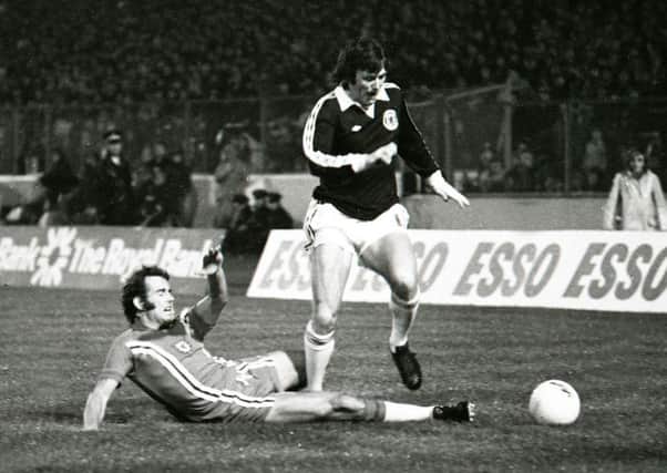 Scotland's Eddie Gray holds off Wales' Malcolm Page (left) Eddie Gray holds off Wales' Malcolm Page in a World Cup qualifier at Hampden in 1976. Picture: SNS