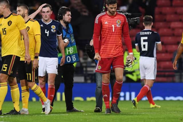 A despondent Craig Gordon leaves the field after being beaten four times by Belgium last night. Picture: SNS.