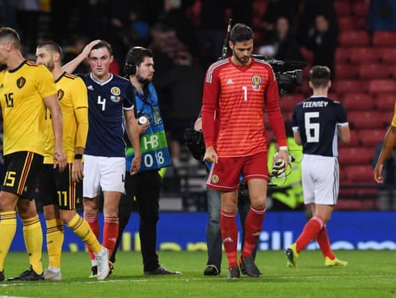 A despondent Craig Gordon leaves the field after being beaten four times by Belgium last night. Picture: SNS.