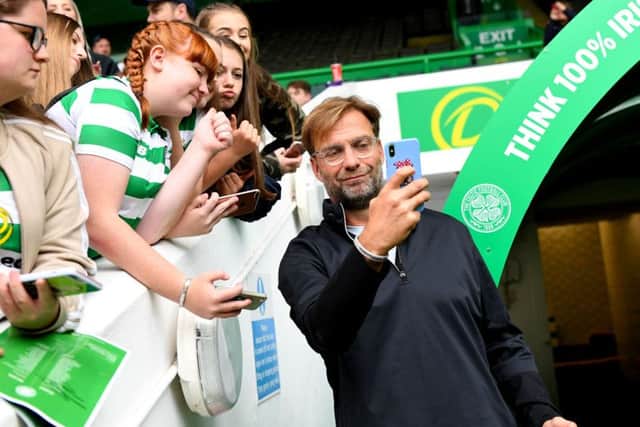 Liverpool manager Jurgen Klopp takes a selfie with Celtic fans. Picture: SNS