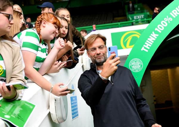 Liverpool manager Jurgen Klopp takes a selfie with Celtic fans. Picture: SNS