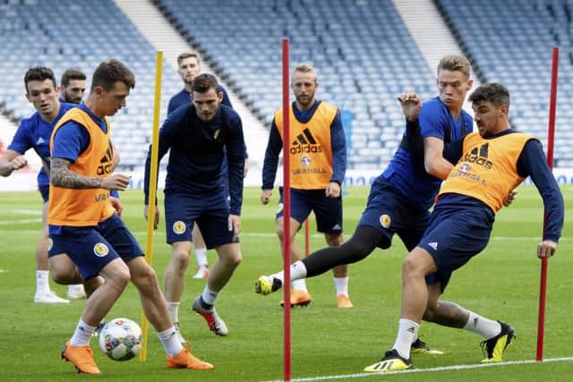 Scott McTominay tussles with Callum Paterson as Ryan Jack gets on the ball in Scotlands training session at Hampden ahead of the clash with Albania. Picture: SNS.