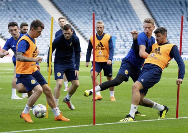 Scott McTominay tussles with Callum Paterson as Ryan Jack gets on the ball in Scotlands training session at Hampden ahead of the clash with Albania. Picture: SNS.