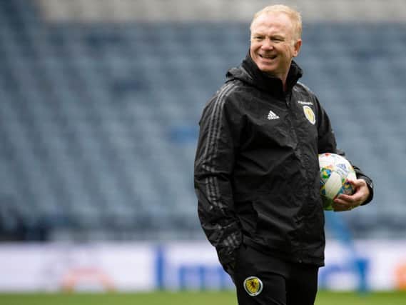Alex McLeish will continue with the back three against Albania.