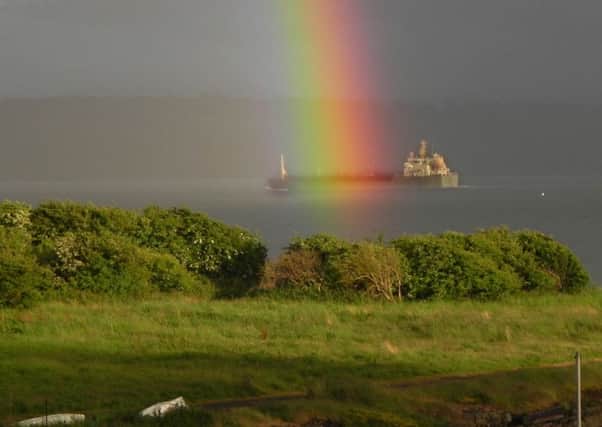 A watergaw  or rainbow  seems to bathe a ship in the Firth of Forth in its brightly coloured lights (Picture: Bill Runciman)