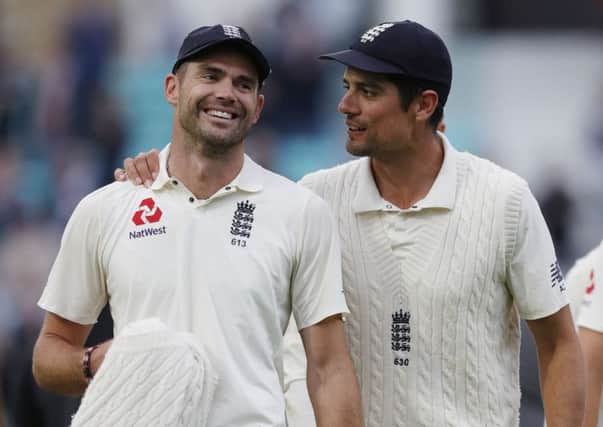 James Anderson, left, is congratulated by Alastair Cook after breaking Glenn McGraths record. Picture: Getty.