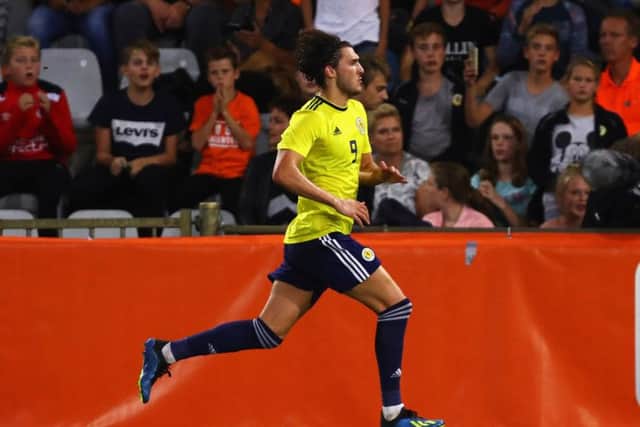 Fraser Hornby runs off to celebrate scoring Scotlands winning goal from the penalty spot. Picture: Getty.