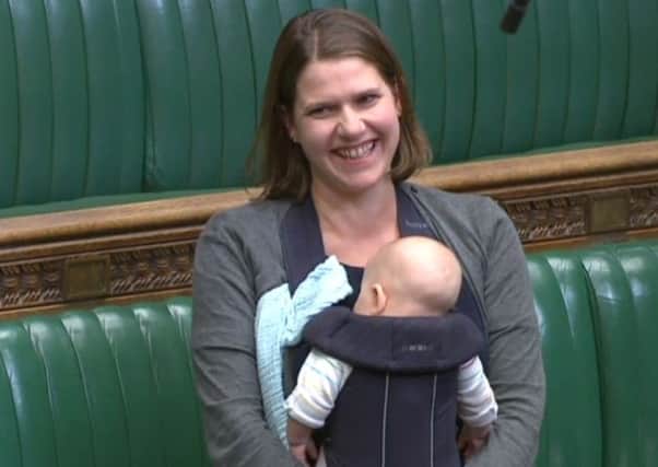 Jo Swinson with her son Gabriel in her Commons seat to listen to the closing remarks of a discussion about proxy voting. Picture: PA