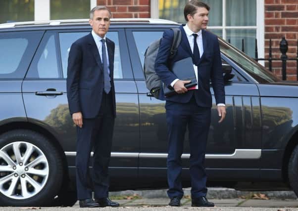 Mark Carney, left,  leaves No.10 with an  aide after addressing the Cabinet. Picture: PA