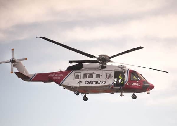 Rescuers are being assisted by a Coastguard rescue helicopter. Picture: John Devlin
