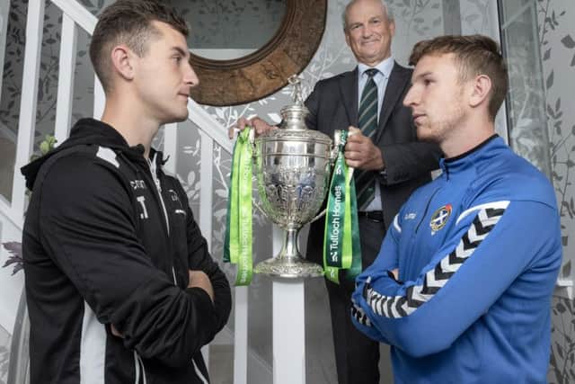 Lovat captain Lewis Tawse, left, with George Fraser of Tulloch Homes, and Newtonmore captain Andy Mackintosh, right.  Picture: Neil Paterson