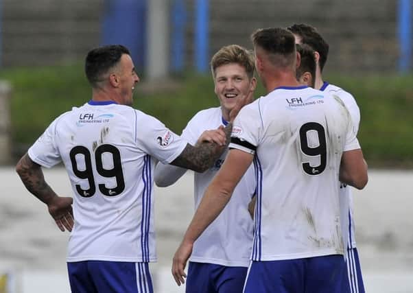 Peterhead's Willie Gibson celebrates his goal with Rory McAllister and Derek Lyle, who also got on the scoresheet (picture by Duncan Brown).