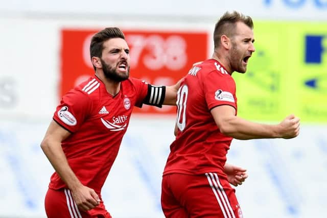 Graeme Shinnie, left, celebrates with goalscorer Niall McGinn after telling him the free-kick was 'for a left-footer'. Picture: SNS