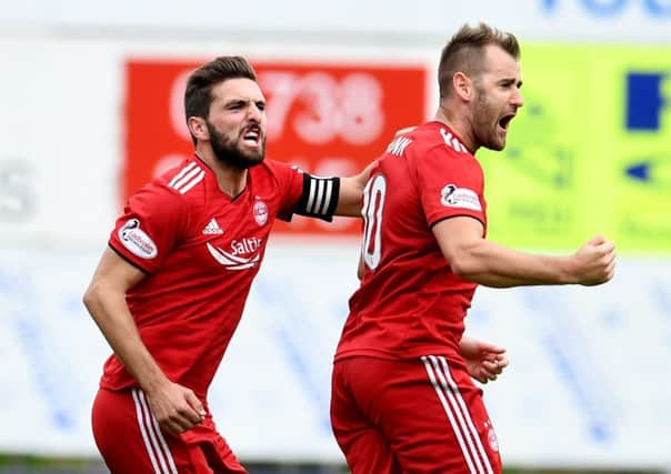 Graeme Shinnie, left, celebrates with goalscorer Niall McGinn after telling him the free-kick was 'for a left-footer'. Picture: SNS