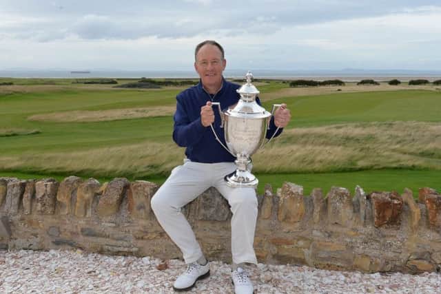 Gary Orr poses with the trophy after his one-shot victory in the Scottish Senior Open at Craigielaw. Picture: Mark Runnacles/Getty Images