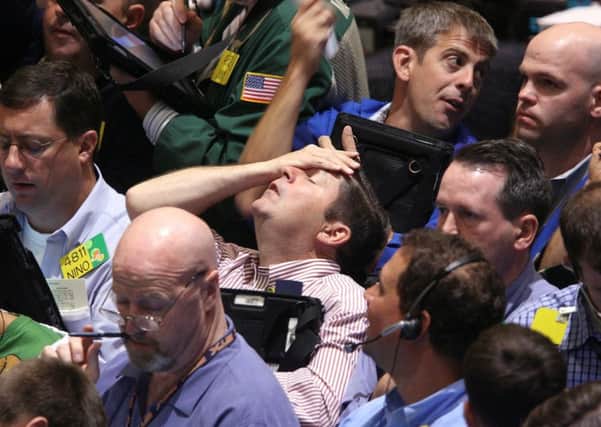 US traders showed the strain as the financial crisis grew across the globe ten years ago. Picture: AP Photo/Seth Wenig, File