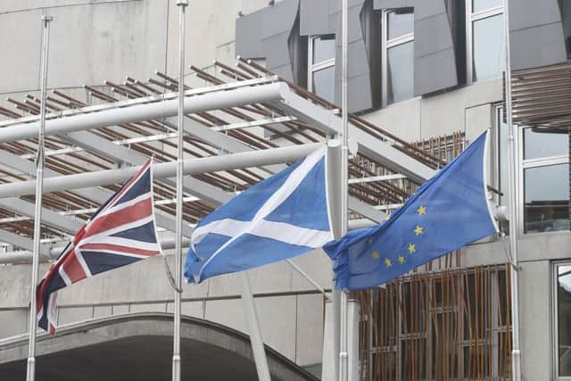 Flags fly at half mast outside the Scottish Parliament.