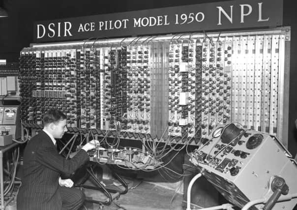 Electronic engineer Edward Newman inspects the Pilot Model ACE, the prototype of the Automatic Computing Engine (ACE), during a press day at the National Physical Laboratory at Bushy Park in Teddington, London, 29th November 1950. The machine was designed by Alan Turing before he left the National Physical Laboratory in 1947. (PIC: Jimmy Sime/Central Press/Hulton Archive/Getty Images)