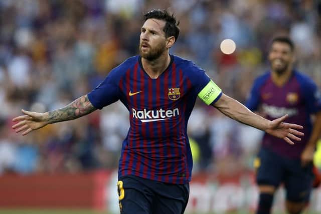 Lionel Messi celebrates his stunning freee-kick opener against PSV Eindhoven. Picture: Manu Fernandez/AP