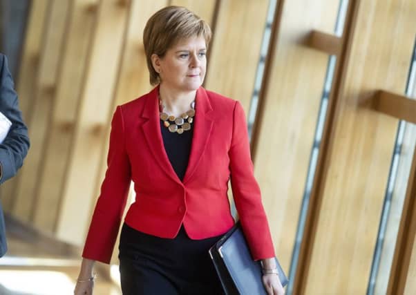 First Minister Nicola Sturgeon walks to FMQs.
